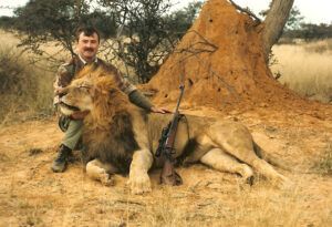 Bob Kern, the world's lead hunting consultant, posing with a trophy lion he just claimed